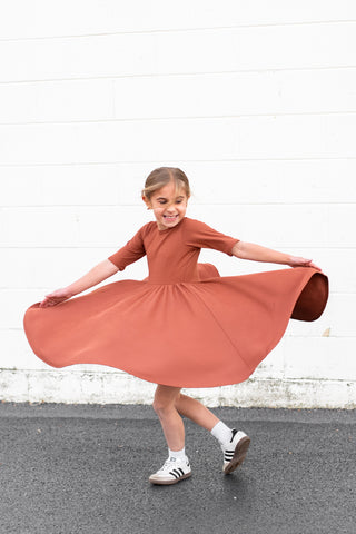 MID SLEEVE TWIRL DRESS- Rust Micro Rib