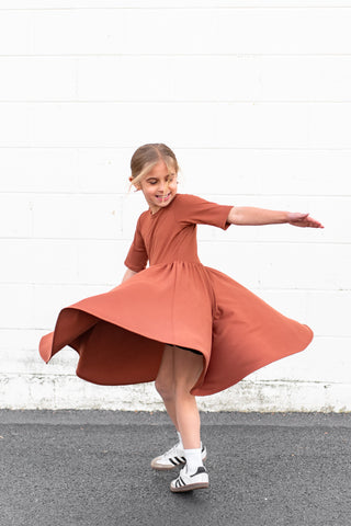 MID SLEEVE TWIRL DRESS- Rust Micro Rib